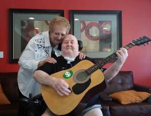 Man holding guitar with mom